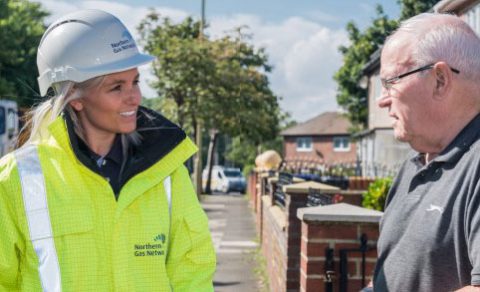 A Northern Gas Networks employee talking to a man on a residential street