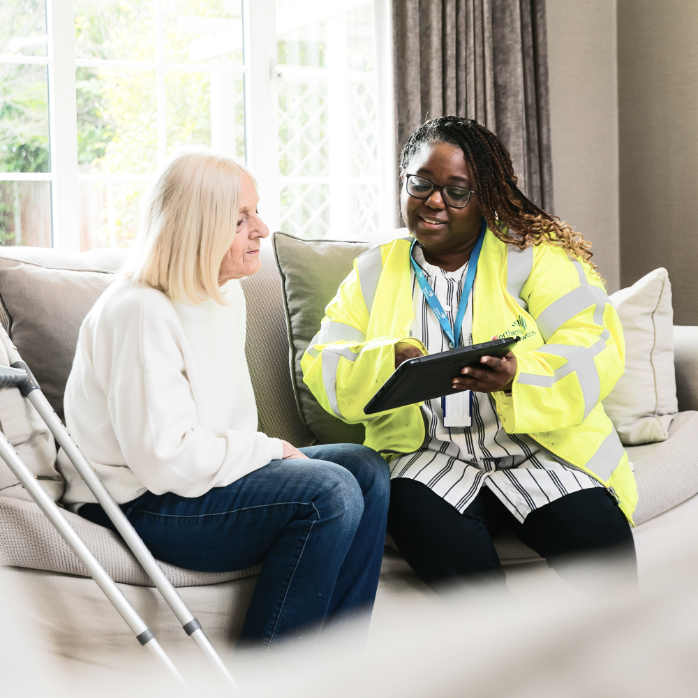 Northern Gas employee sitting in living room with vulnerable customer