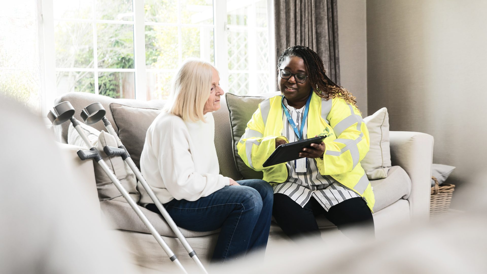 Northern Gas employee sitting in living room with vulnerable customer
