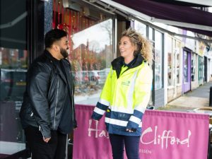 Image of NGN colleague talking to owner of small business in local shopping area