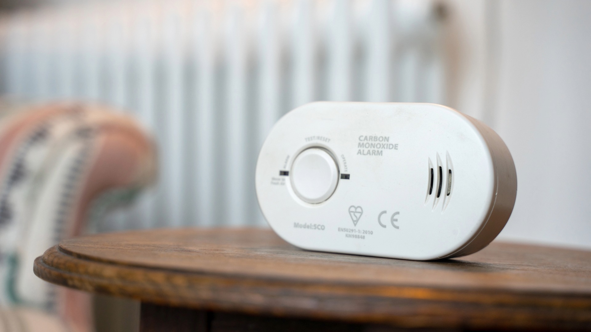 Image of a carbon monoxide (CO) alarm on a coffee table is home.