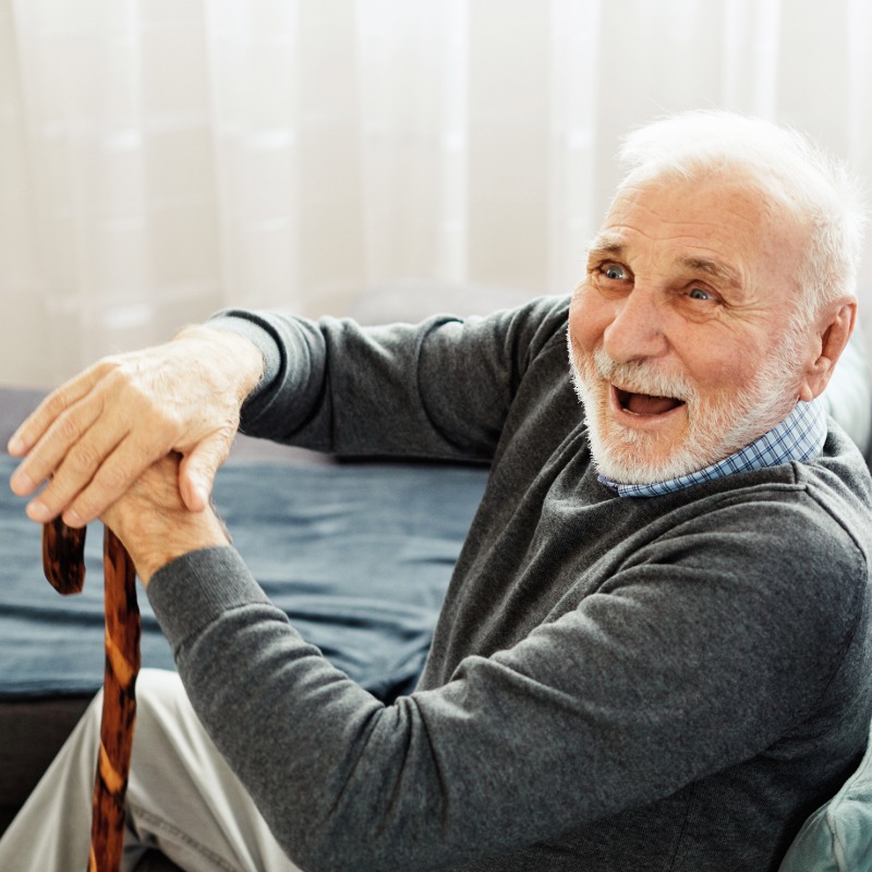 Image of an elderly man with walking stick.